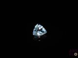 a close up of a blue diamond on a black background