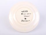 a white plate with writing on it on a white surface