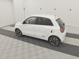 an image of a small white car parked in a garage