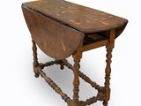 an old wooden table with a small drop leaf on the top