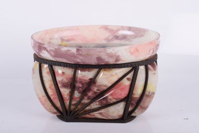 a pink and white bowl sitting on top of a table