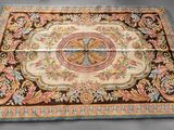 a close up of a rug on a table with a gray background