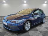 a blue car parked on a checkered floor in a garage