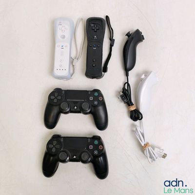 several video game controllers sitting next to each other on a table