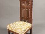 an old wooden chair with a yellow and white upholstered seat