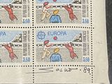 four stamps with a picture of a woman playing tennis on them