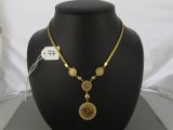 a close up of a necklace on a mannequin with a price tag