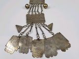 an image of a silver necklace with metal charms and a chain