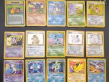 the pokemon cards are lined up on a black surface