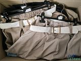 a cardboard box filled with clothes and a pair of pants