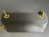 a black purse with a gold chain hanging from it