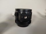 a black camera lens sitting on a white table