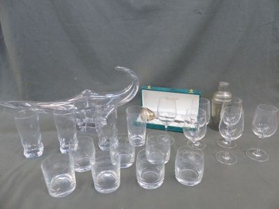 many glasses and a pitcher sitting on a table