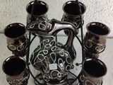 a picture of a set of six vases and a pitcher