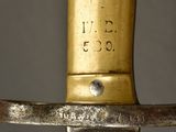 a close up of a sword with a gold handle