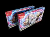two boxes of pokemon trading cards on a black background