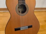an acoustic guitar sitting on top of a hard wood floor