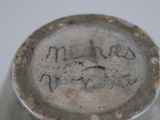 a close up of a white vase with writing on it