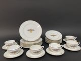 a lot of plates and cups that are sitting on a table