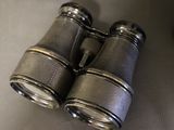 a pair of binoculars sitting on a table next to a pair of shoes