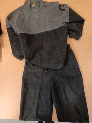 two pieces of clothing hanging on a wall next to a pair of shoes