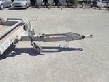 a trailer with a trailer attached to it in a parking lot