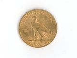 a gold coin with a bird on it on a white surface