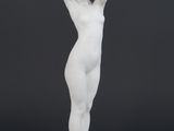 a white marble statue of a woman holding her hands on her head