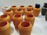 many vases that are sitting on a table