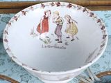 a cup and saucer with a picture of a couple of people on it