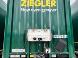 a green container with a sign on it that says ziegler now even greener