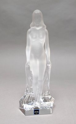 crystal figurine of a woman standing on a clear base