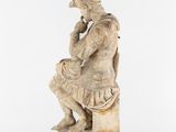 an image of a statue of a man sitting on a bench
