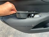 a person opening the door handle of a car
