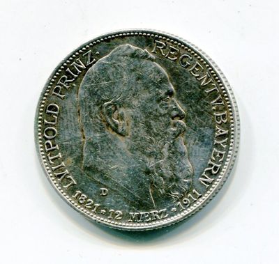Gros plan sur une pièce de monnaie portant le visage d'un homme