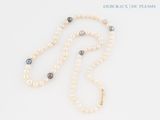 necklace with pearls and a gold clasp on a white background