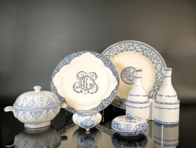 several pieces of blue and white china sitting on a table