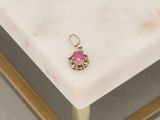 silver and pink earrings on a marble table with a gold frame