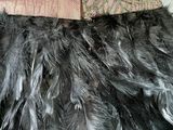 a close up of a dress with feathers on it