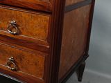 a small chest of drawers on a small table