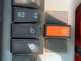 a close up of a car ' s dashboard with the buttons on