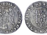 une pièce d'argent sur laquelle figurent des armoiries et un bouclier