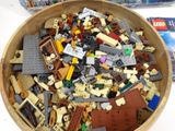 a bowl full of legos sitting on a table
