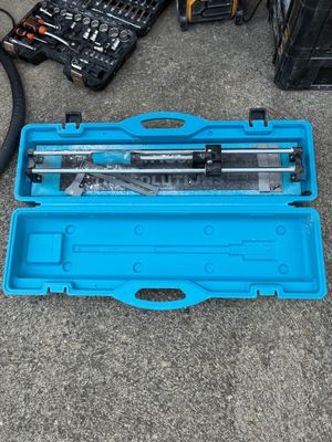 a blue tool case with tools in it on the ground