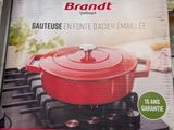 packaging of a brand new red cookware on display in a store