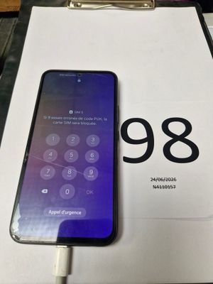an iphone is sitting on top of a box with the number 98 on it