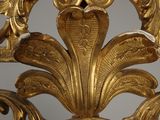 a gold sculpture with a clock on top of it