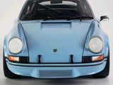a blue car that is sitting on a white surface