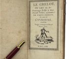 an old book with a pen sitting on top of it next to a pen