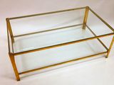 brass and glass coffee table with a glass top
